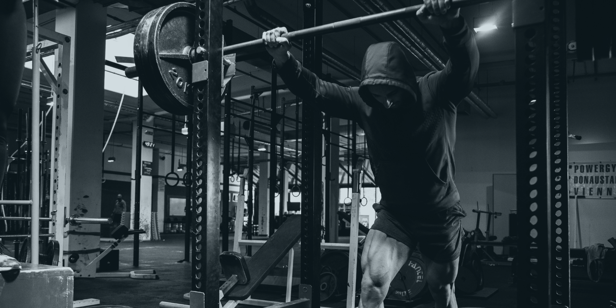 Person lifting a barbell in a gym setting