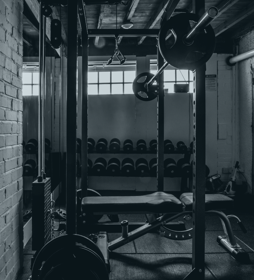 Homegym with weightlifting equipment and weights.